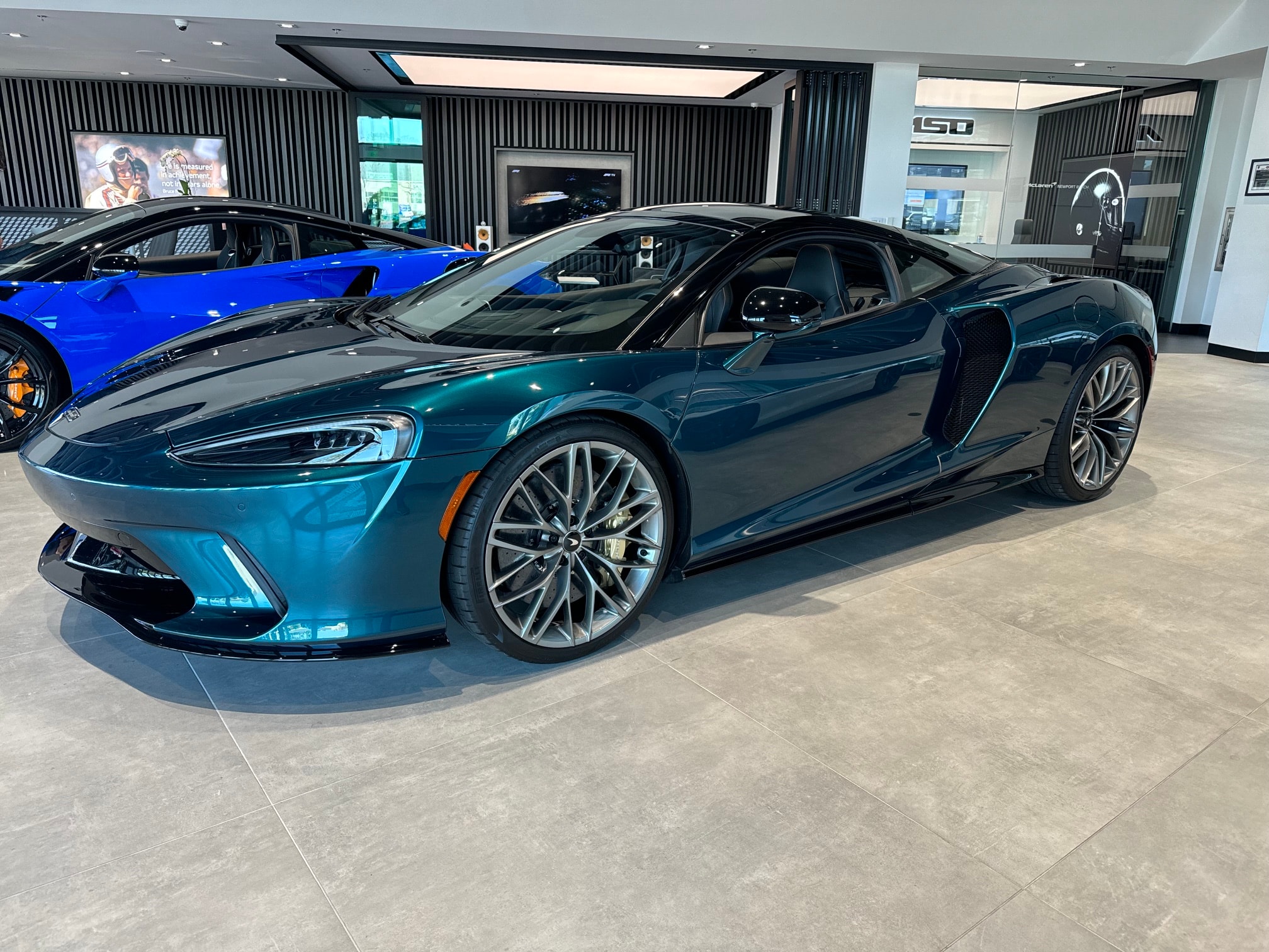 McLaren GT in Serpentine Green with gold brake calipers — grand touring supercar at its finest.