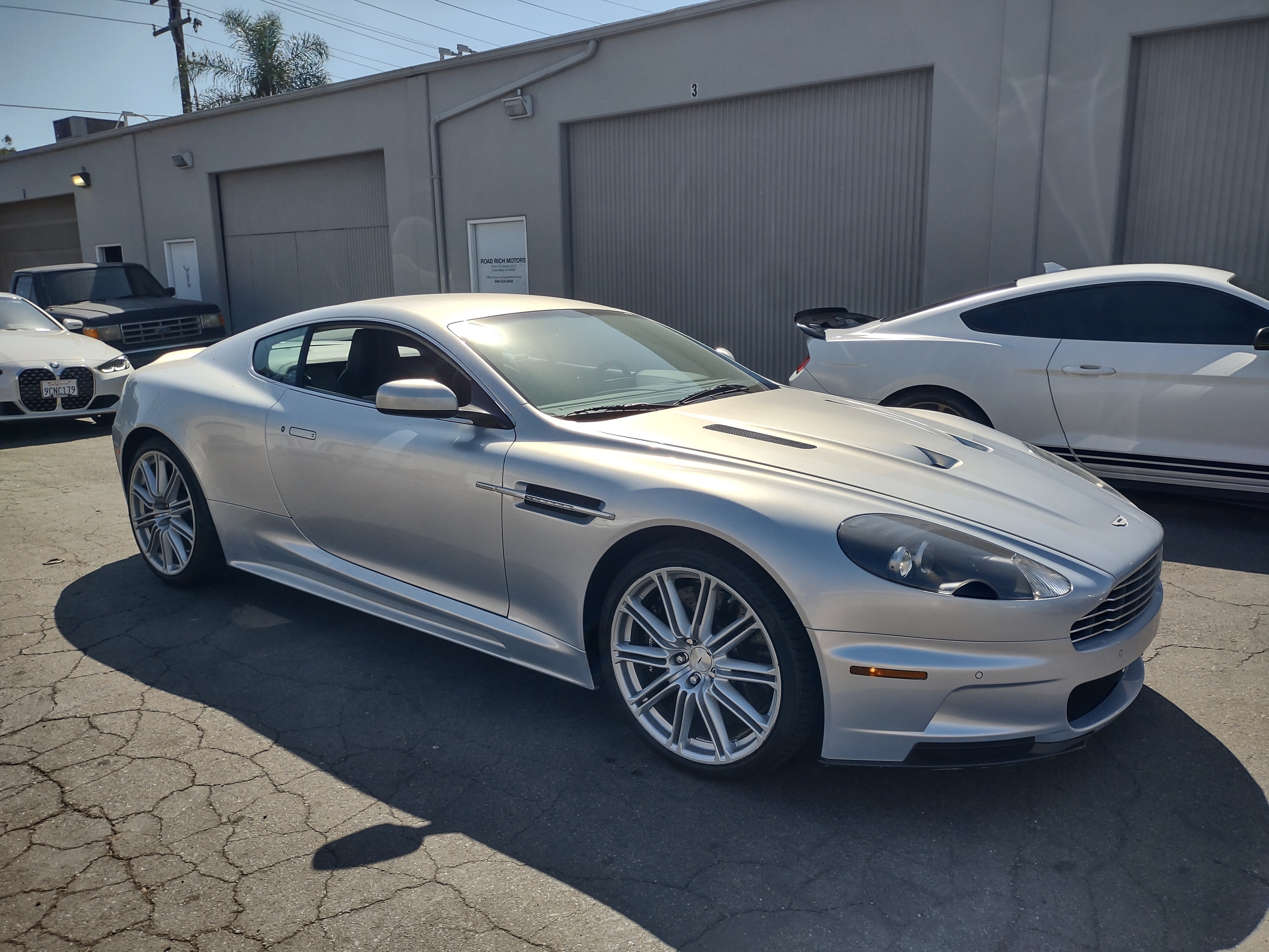Aston Martin DBS — effortless British GT in silver.